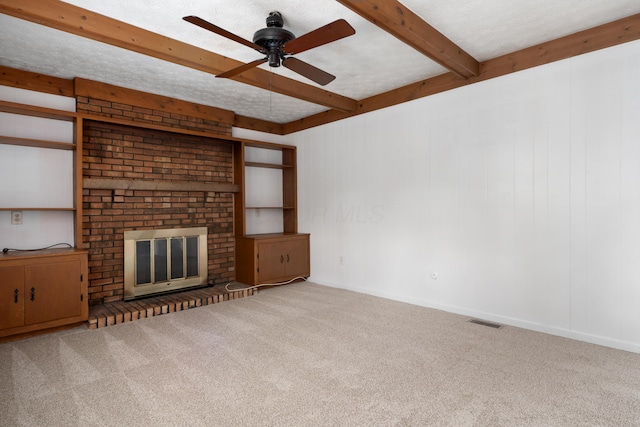 3456 Merrydawn Dr, Columbus, OH 43221 - unfurnished living room with beam ceiling, carpet flooring, ceiling fan, a fireplace, and baseboards