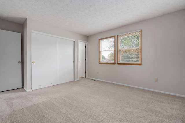 3456 Merrydawn Dr, Columbus, OH 43221 - unfurnished bedroom with carpet floors, a textured ceiling, a closet, and baseboards