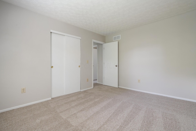 3456 Merrydawn Dr, Columbus, OH 43221 - unfurnished bedroom featuring light colored carpet, a textured ceiling, a closet, and baseboards