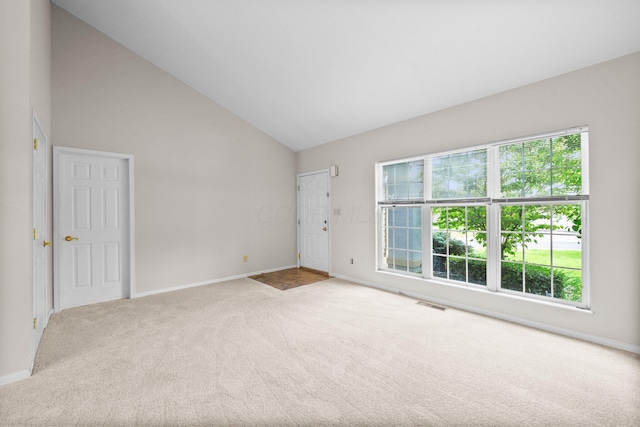 857 Village Dr, Delaware, OH 43015 - carpeted empty room with healthy amount of natural light, baseboards, and vaulted ceiling
