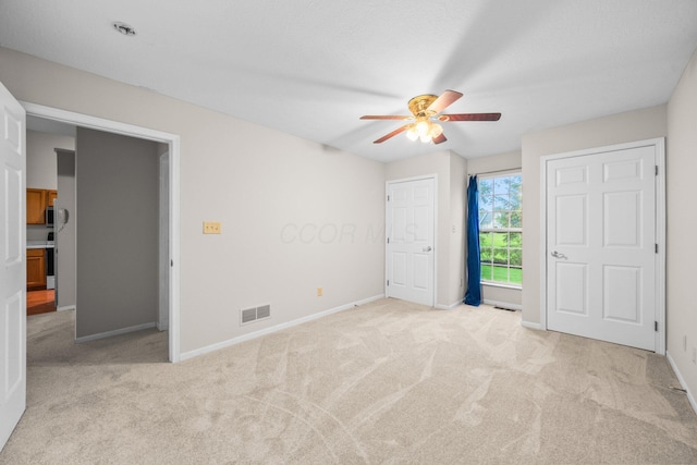 857 Village Dr, Delaware, OH 43015 - unfurnished bedroom featuring carpet flooring, baseboards, and ceiling fan