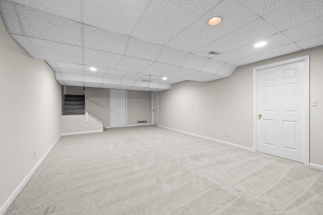 857 Village Dr, Delaware, OH 43015 - finished basement with carpet flooring, recessed lighting, baseboards, stairway, and a paneled ceiling