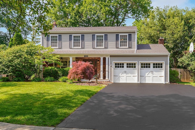 1332 Castleton Rd N, Columbus, OH 43220 - view of front of house with driveway, a chimney, and a garage