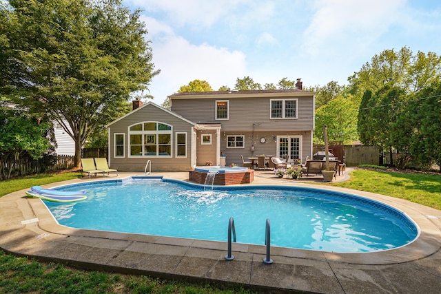 1332 Castleton Rd N, Columbus, OH 43220 - back of house featuring an outdoor hot tub, a chimney, and a patio area