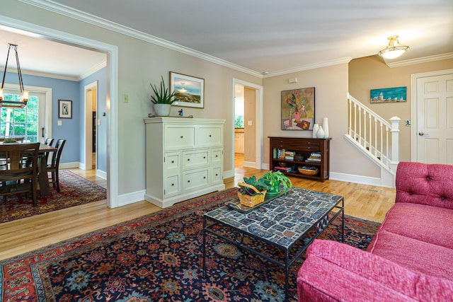 1332 Castleton Rd N, Columbus, OH 43220 - living room featuring light wood finished floors, stairs, ornamental molding, and baseboards