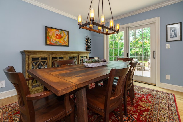 1332 Castleton Rd N, Columbus, OH 43220 - dining room with a chandelier, baseboards, ornamental molding, and wood finished floors