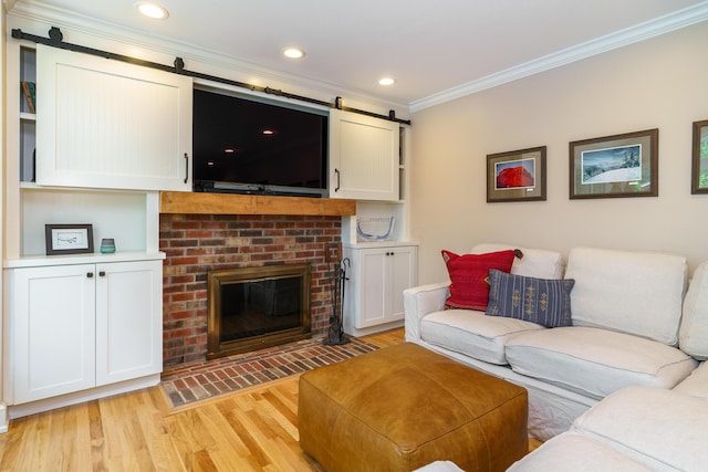 1332 Castleton Rd N, Columbus, OH 43220 - living area featuring crown molding, a barn door, light wood finished floors, a brick fireplace, and recessed lighting