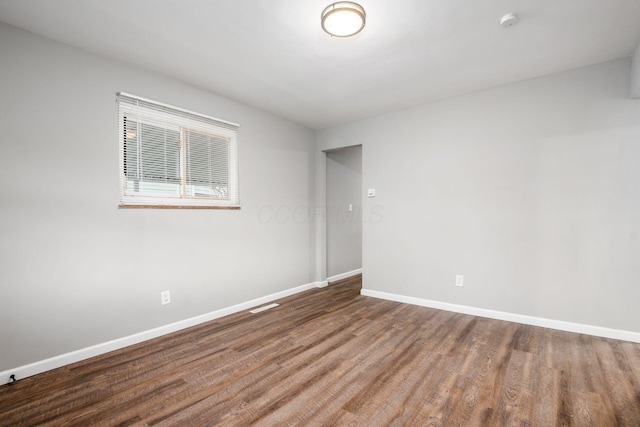 2280 Velma Ave, Columbus, OH 43211 - empty room featuring baseboards, wood finished floors, and a smoke detector