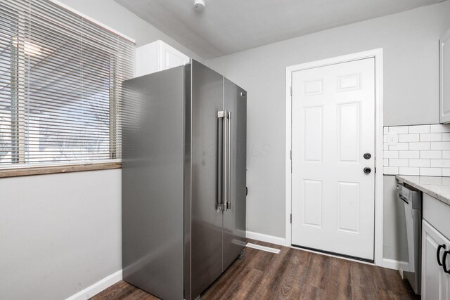 2280 Velma Ave, Columbus, OH 43211 - kitchen with stainless steel appliances, white cabinets, dark wood-style floors, and baseboards