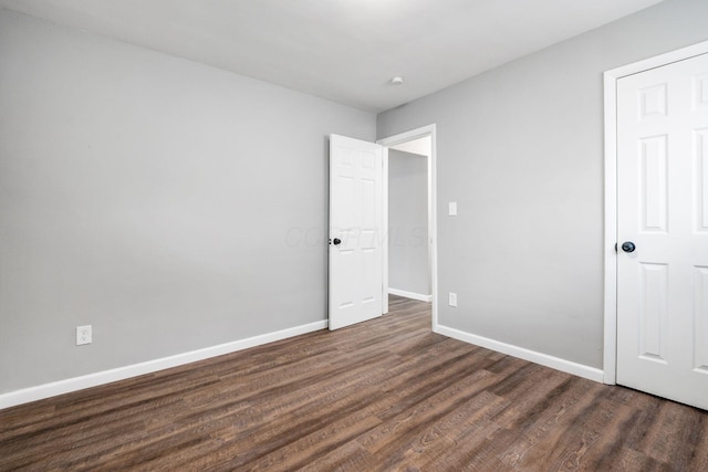 2280 Velma Ave, Columbus, OH 43211 - unfurnished bedroom with dark wood-style floors and baseboards