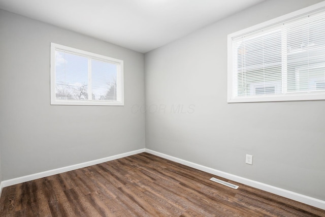 2280 Velma Ave, Columbus, OH 43211 - spare room featuring baseboards and dark wood-type flooring