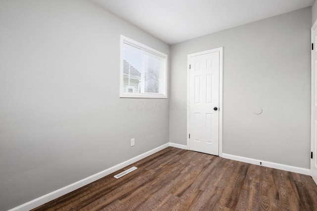 2280 Velma Ave, Columbus, OH 43211 - unfurnished bedroom with baseboards and dark wood-style floors