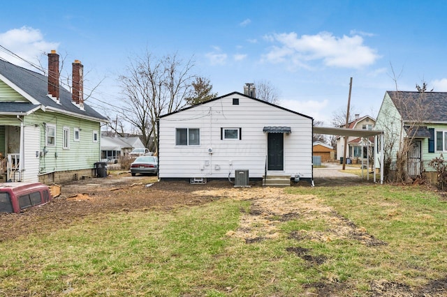 2280 Velma Ave, Columbus, OH 43211 - back of house with entry steps, central air condition unit, a yard, and a carport