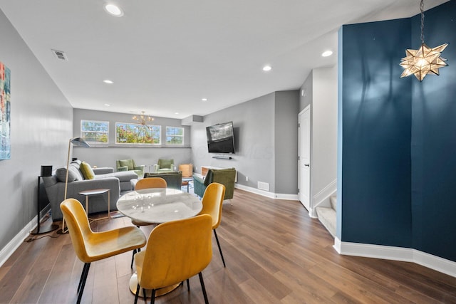 5781 Glendavon Loop, Dublin, OH 43016 - dining area featuring a chandelier, baseboards, wood finished floors, recessed lighting, and stairway