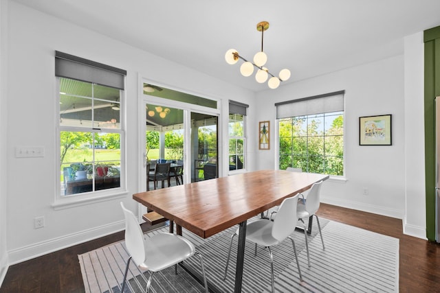 5781 Glendavon Loop, Dublin, OH 43016 - dining space featuring baseboards, dark wood-style flooring, and a chandelier