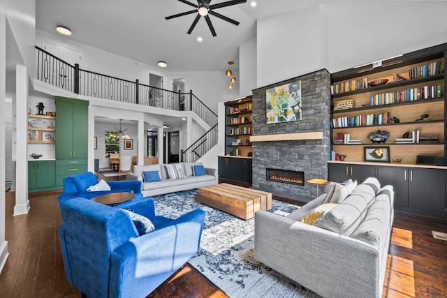 5781 Glendavon Loop, Dublin, OH 43016 - living area with a ceiling fan, a high ceiling, stairs, a fireplace, and wood finished floors