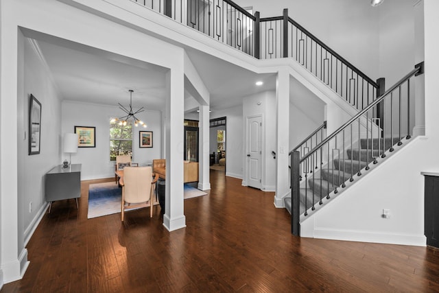 5781 Glendavon Loop, Dublin, OH 43016 - foyer entrance featuring a chandelier, hardwood / wood-style flooring, stairway, baseboards, and a towering ceiling