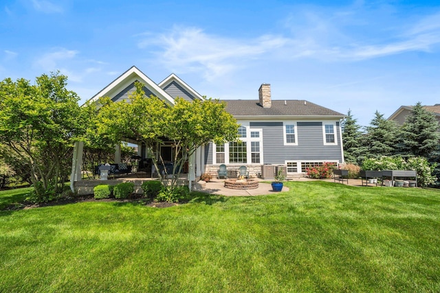 5781 Glendavon Loop, Dublin, OH 43016 - back of house featuring a patio, a yard, a chimney, and an outdoor living space with a fire pit