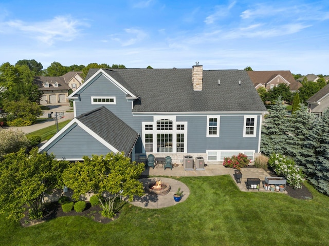 5781 Glendavon Loop, Dublin, OH 43016 - back of house featuring a fire pit, a patio area, a chimney, a yard, and cooling unit