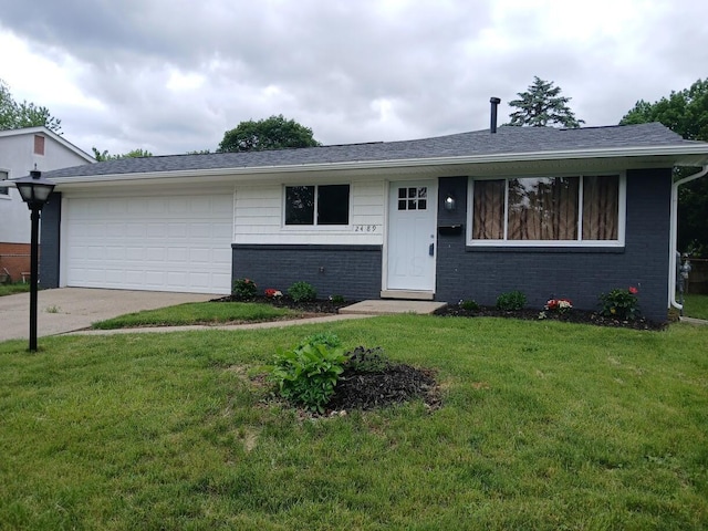 2489 Lipton Rd, Columbus, OH 43232 - view of front facade featuring brick siding, driveway, a front yard, and an attached garage