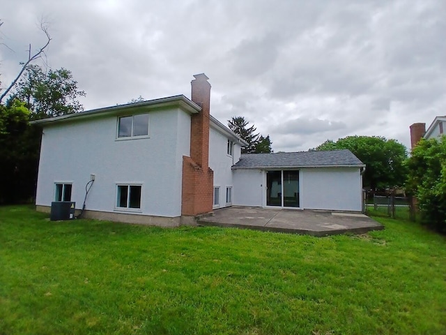 2489 Lipton Rd, Columbus, OH 43232 - back of property featuring a patio, a chimney, and stucco siding