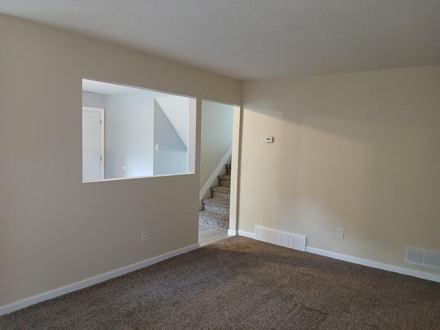 2489 Lipton Rd, Columbus, OH 43232 - carpeted spare room featuring stairway, a textured ceiling, and baseboards