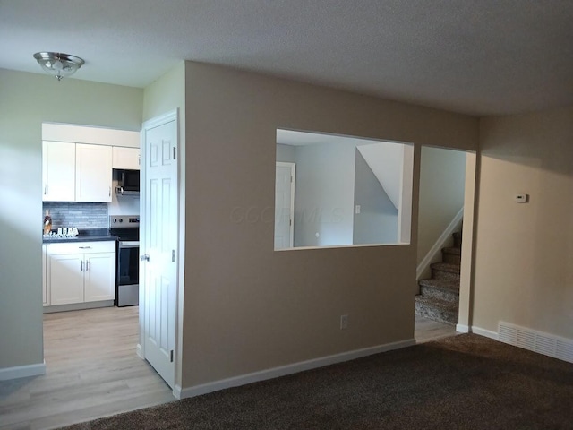 2489 Lipton Rd, Columbus, OH 43232 - unfurnished living room featuring stairway and baseboards