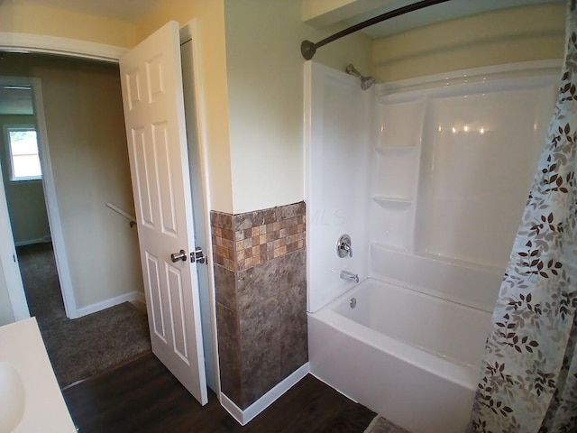 2489 Lipton Rd, Columbus, OH 43232 - full bathroom with shower / tub combo, wood finished floors, tile walls, and a wainscoted wall