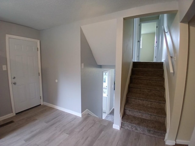 2489 Lipton Rd, Columbus, OH 43232 - staircase with wood finished floors and baseboards