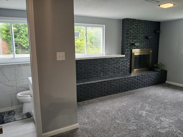 2489 Lipton Rd, Columbus, OH 43232 - unfurnished living room with healthy amount of natural light, a fireplace, and baseboards