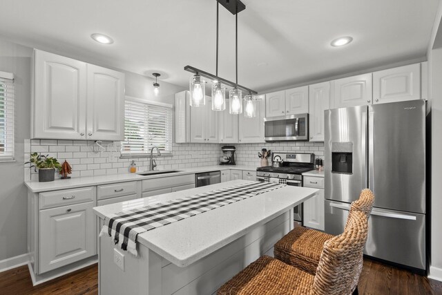 3544 Devin Rd, Grove City, OH 43123 - kitchen with stainless steel appliances, a sink, decorative backsplash, a center island, and recessed lighting
