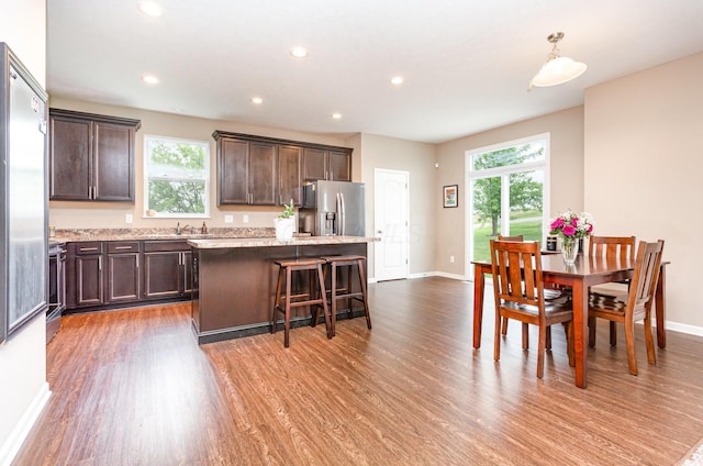 1705 Bent Creek Dr, Lancaster, OH 43130 - kitchen featuring stainless steel refrigerator with ice dispenser, dark brown cabinetry, wood finished floors, a kitchen island, and recessed lighting