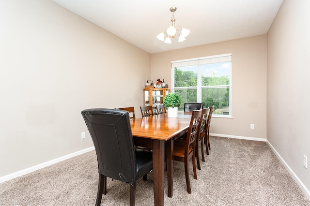 1705 Bent Creek Dr, Lancaster, OH 43130 - dining area featuring a chandelier, light colored carpet, and baseboards