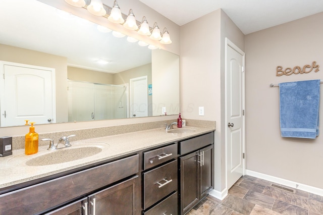 1705 Bent Creek Dr, Lancaster, OH 43130 - bathroom with double vanity, baseboards, a shower stall, and stone finish flooring