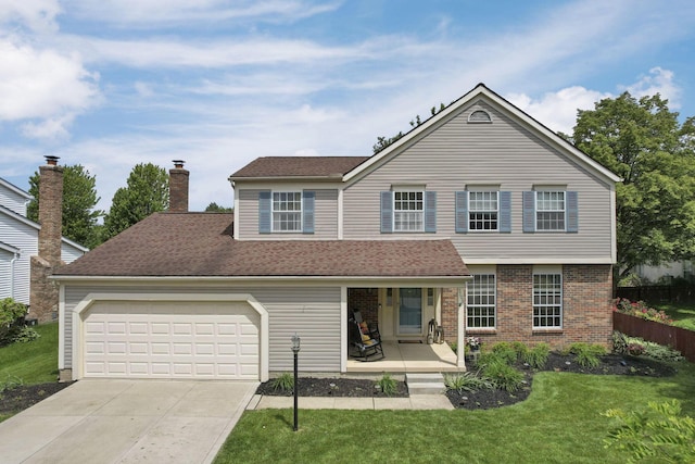 5706 Turner Ln, Hilliard, OH 43026 - view of front facade with a porch, concrete driveway, a garage, and brick siding