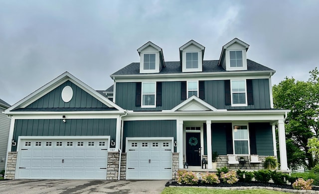 5305 Tarlton Blvd, Hilliard, OH 43026 - view of front facade featuring a porch, board and batten siding, and stone siding