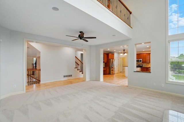 273 Blue Jacket Cir, Pickerington, OH 43147 - unfurnished living room with light carpet, a ceiling fan, baseboards, stairs, and recessed lighting