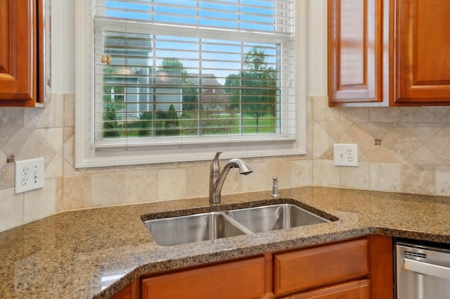 273 Blue Jacket Cir, Pickerington, OH 43147 - kitchen with a sink, stainless steel dishwasher, light stone countertops, brown cabinetry, and backsplash