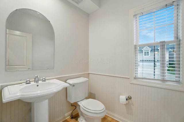 273 Blue Jacket Cir, Pickerington, OH 43147 - half bathroom featuring a wainscoted wall, toilet, a sink, and wood finished floors
