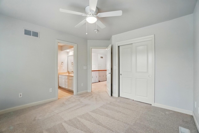 273 Blue Jacket Cir, Pickerington, OH 43147 - unfurnished bedroom with light colored carpet, a closet, baseboards, ensuite bath, and ceiling fan