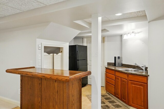 273 Blue Jacket Cir, Pickerington, OH 43147 - kitchen featuring freestanding refrigerator, a sink, dark countertops, brown cabinetry, and a peninsula
