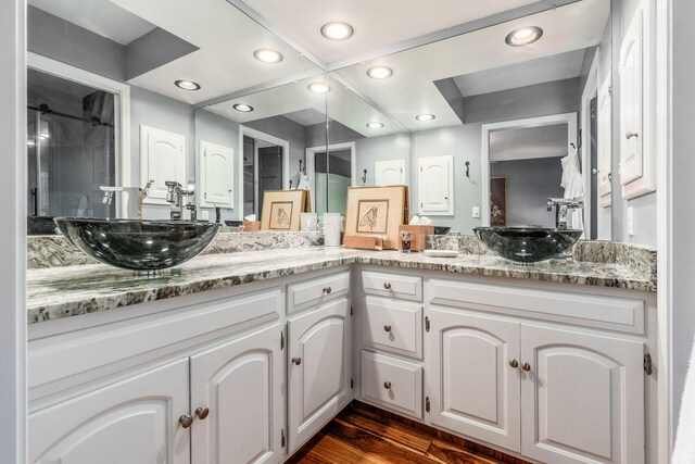 8547 Pitlochry Ct, Dublin, OH 43017 - full bath with double vanity, a stall shower, wood finished floors, and recessed lighting