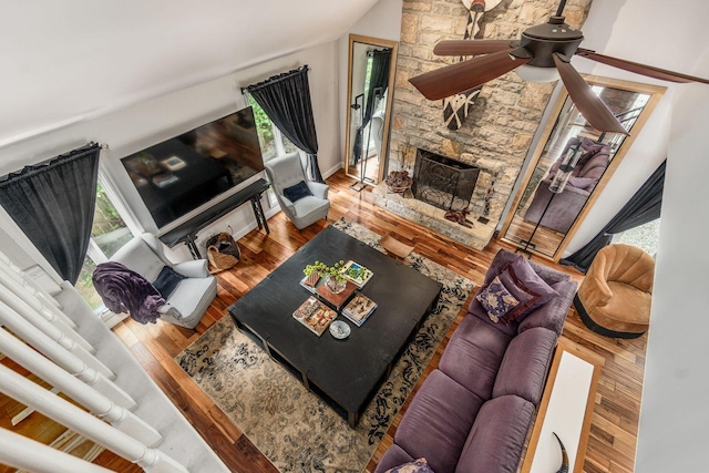 8547 Pitlochry Ct, Dublin, OH 43017 - living room featuring ceiling fan, a fireplace, wood finished floors, vaulted ceiling, and baseboards