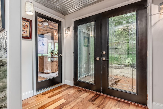 8547 Pitlochry Ct, Dublin, OH 43017 - doorway to outside featuring french doors, light wood finished floors, and baseboards