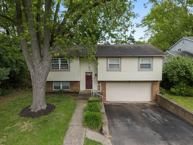 4373 Valley Quail Blvd S, Westerville, OH 43081 - raised ranch with an attached garage, driveway, brick siding, and a front yard