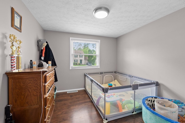 4373 Valley Quail Blvd S, Westerville, OH 43081 - bedroom with dark wood-style floors, a textured ceiling, and baseboards