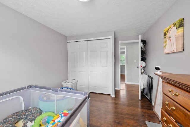 4373 Valley Quail Blvd S, Westerville, OH 43081 - bedroom featuring dark wood-style floors, radiator, a textured ceiling, a closet, and baseboards