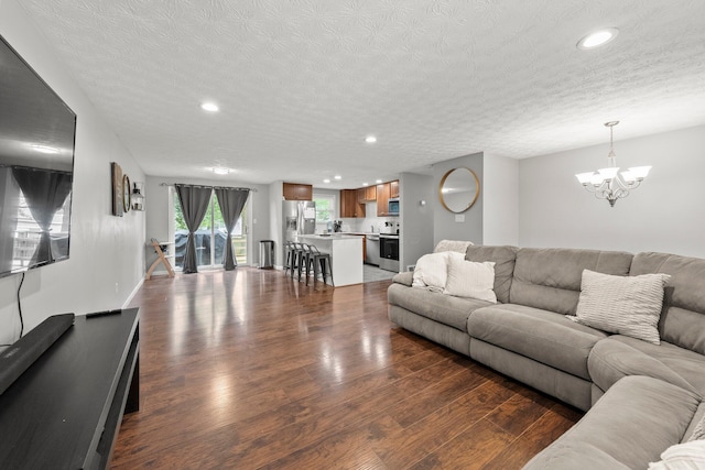 4373 Valley Quail Blvd S, Westerville, OH 43081 - living room with dark wood-type flooring, a chandelier, recessed lighting, and a textured ceiling