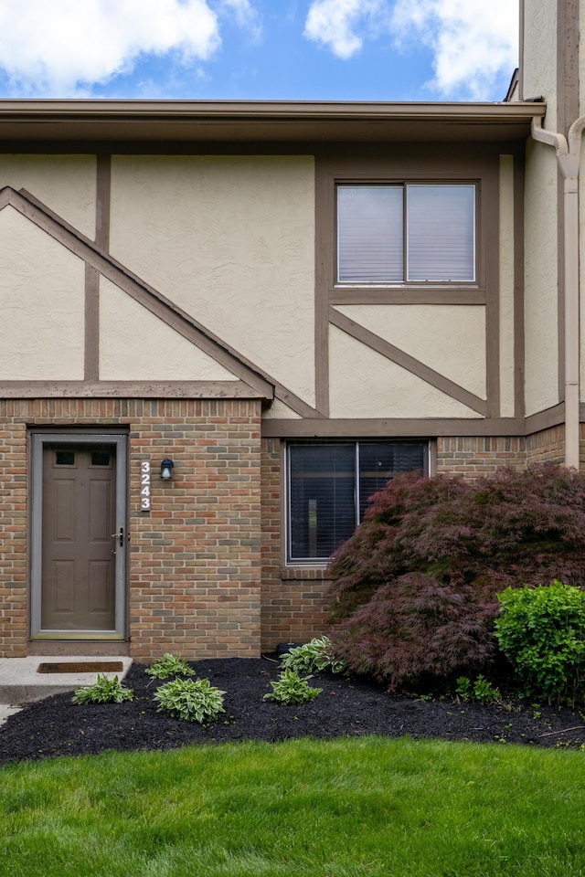 3243 Brookview Way Unit 68, Columbus, OH 43221 - doorway to property featuring stucco siding and brick siding
