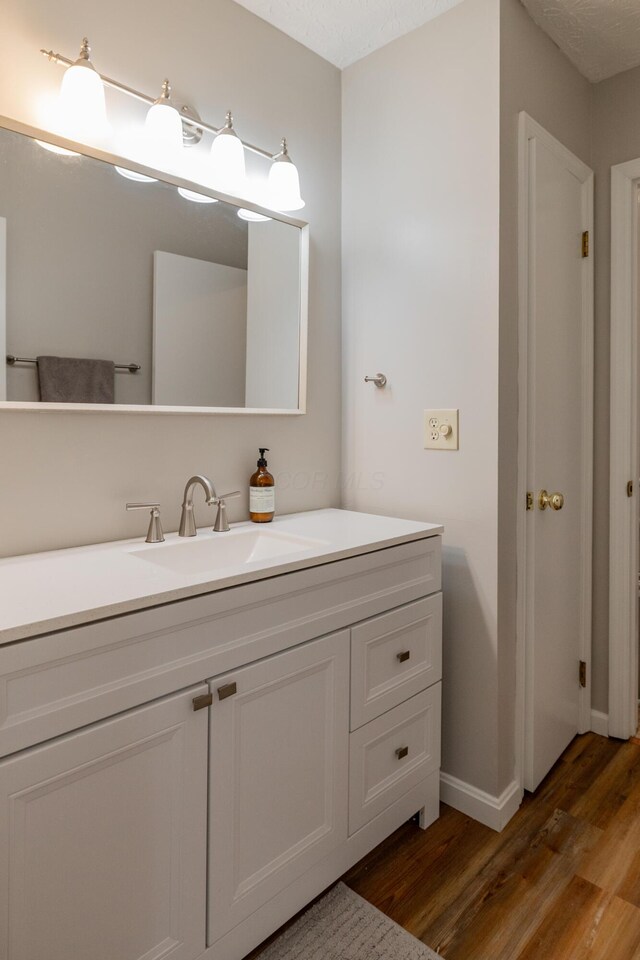 3243 Brookview Way Unit 68, Columbus, OH 43221 - bathroom with wood finished floors, vanity, and baseboards